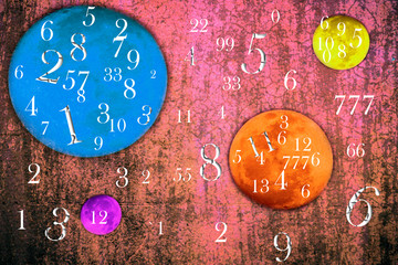 Multi-colored planets on a pink background and numbers, numerology
