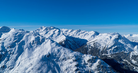 Horizontal Austrian Alps panorama - background image of snowy mountains and peaks near Zürs, Austria