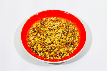 Hot seasoning in plate isolated on white background. Mix of different spices and sea salt. Traditional ingredient for cooking Italian food