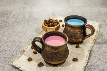 Obraz na płótnie Canvas Trendy drink blue and pink latte. Lavender or spirulina and rose, beetroot or raspberry coffee. Stone concrete background