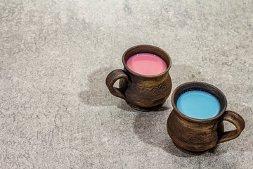 Trendy drink blue and pink latte. Lavender or spirulina and rose, beetroot or raspberry coffee. Stone concrete background