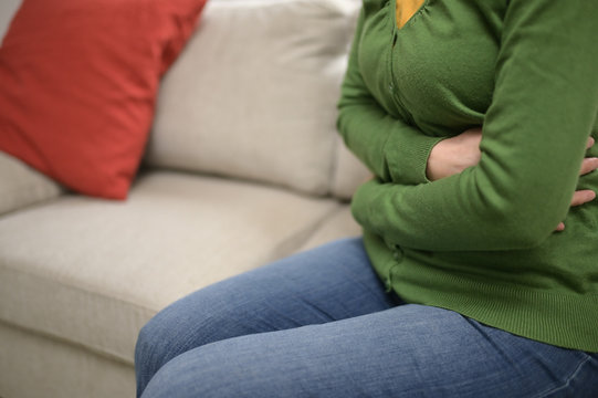 Woman Hands On Front Stomach Painful