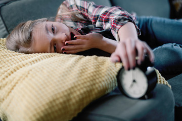 Sweet little girl fall asleep at sofa. 