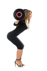 Beautiful woman in elegant dress lifting barbell, concept of healthy lifestyle
