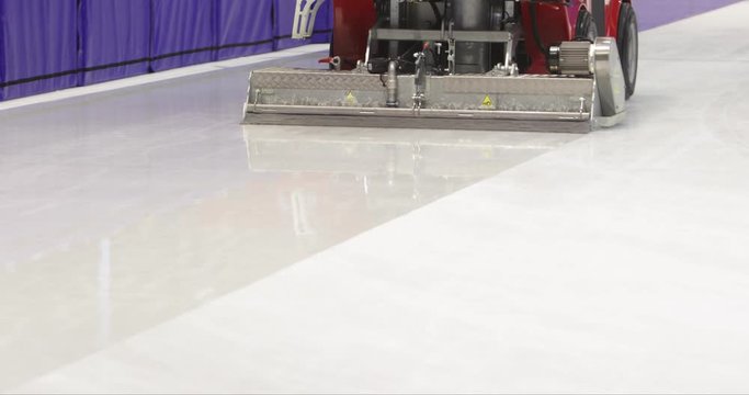 Footage of an ice-resurfacing machine polishing the rink