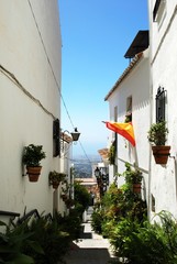 View along an old town side street towards the countryside, Mijas, Spain.