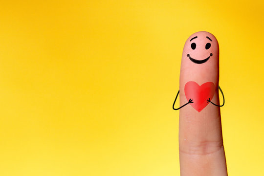 Valentine's day concept. 2 fingers with painted smiling faces symbolize love and friendship.