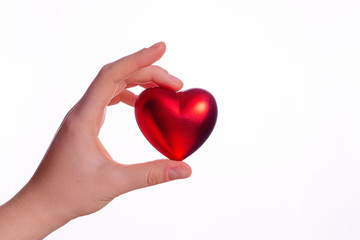 Valentine's day concept. a woman's hand holds a heart on a white background.