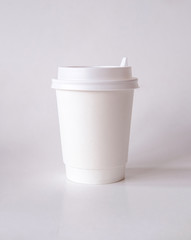 Mock up coffee or tea paper cup with cap on a light background. Logo Template