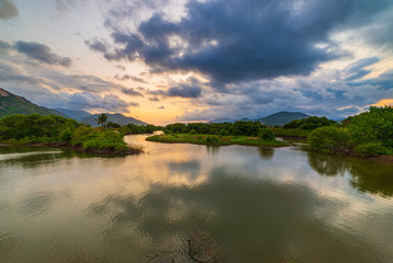Obraz premium Unique sunset sky in Vietnam beautiful Phu Yen province Cam Lap promontory forest hill river ecosystem water reflection colorful cloudscape, travel destination.