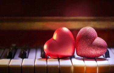 the concept of Valentine's day. The red heart is on the piano keys.