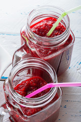 Detox smoothie from apple, beet, carrots, strawberry and spinach in mason jar on  old, wooden background.