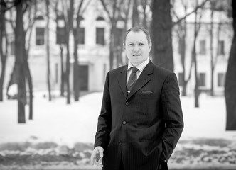 Young handsome business man cheerful with a smile in a blue suit