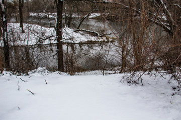 the Ukrainian river in the dark cloudy winter day. The river in city Sumy