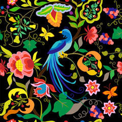 Peacock seamless pattern in vintage style isolated on black background. Vector print with ethnic blue bird and flowers, leaves, grape branches. Folk fashionable stylish element for textiles
