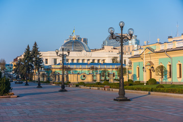 Fototapeta premium Scenic view of Mariyinska square in Kyiv, Ukraine. Row of lanterns, Mariyinsky palace and Ukrainian Parliament building