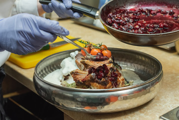 serving a juicy pork with fresh vegetables and original sauce