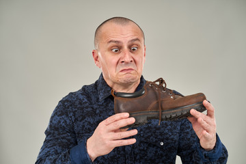 Man holding a stinking shoe