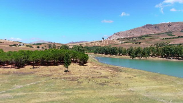 Aerial above turquoise lago poma and surrounding landscape, sicily