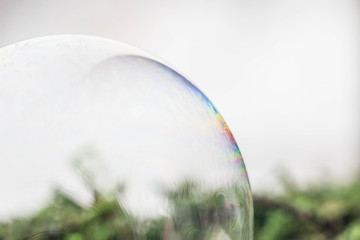Macrophotography of a soap bubble. Multicolored streaks on the surface of the soap bubble