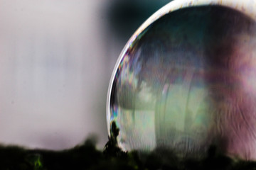 Macrophotography of a soap bubble. Multicolored streaks on the surface of the soap bubble