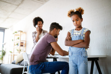 Sad little girl waiting for busy parent attention at home