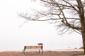 Bench by the sea, foggy morning. Helsinki