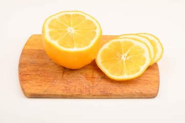 Ripe yellow sliced lemon on a Board on a white background. Close up.
