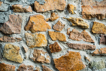 The texture of the old masonry. Background image of a stone-lined wall