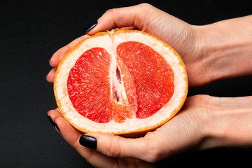 hand holds half of grapefruit