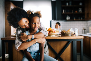 Mother and child having fun preparing healthy food in kitchen