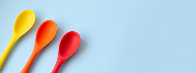 Banner for the site with multi-colored kitchen spoons.