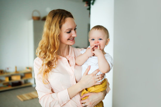 Beautiful Caucasian Blonde Mom Holding Baby