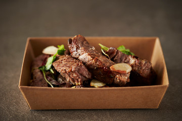 Take out beef steak in paper plate 