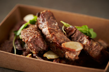 Take out beef steak in paper plate 
