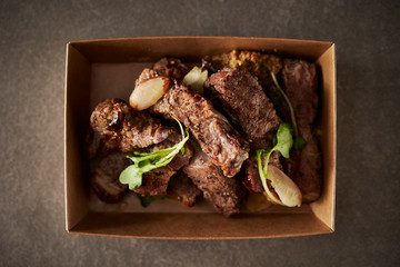 Take out beef steak in paper plate 