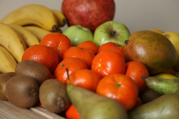 Fruits different: bananas, mandarin, kiwi, pear, apples, fruit pomegranate for the preparation of juices useful and delicious