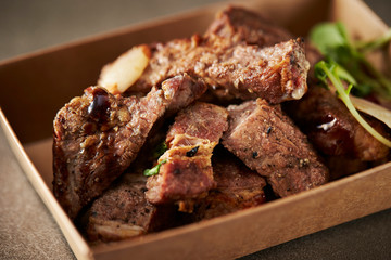Take out beef steak in paper plate 
