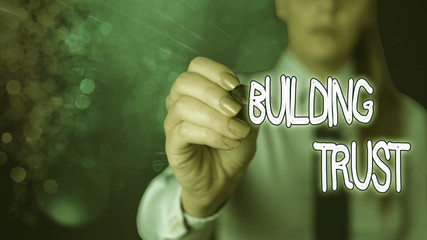 Conceptual hand writing showing Building Trust. Concept meaning activity of emerging trust between...