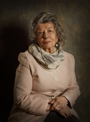 Portrait of an old woman in a scarf and jacket