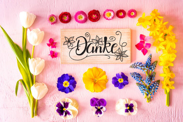 Rustic Wooden Sign With German Calligraphy Danke Means Thank You. Flat Lay With Spring Flower. Wooden Pink Background