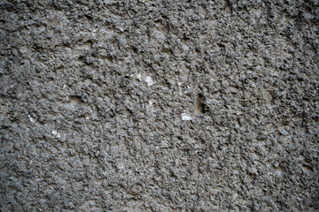 Texture of an old cracked concrete wall. Background image of a worn gray concrete surface