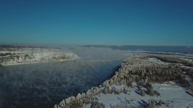 Steam over the river and a view of the city of Bratsk.