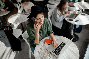 Woman freelancer drinking coffee, work remotely, entrepreneur, work in cowering space, public place, modern people lifestyle, business online concept.