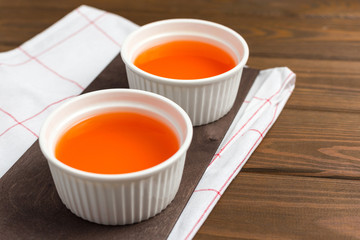 Berry fruit jelly on wooden background, food concept. Two plates with sweet dessert