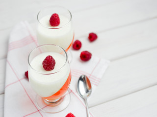 Delicious italian dessert panna cotta with berry jelly on wooden background, food concept