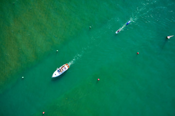 White yacht on blue water in motion. Aerial view