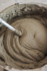 Construction repair work with mixing of glue or concrete in a bucket