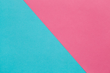 Background of two sheets of colored paper, pink and blue.