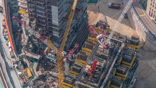 Construction progress of new modern skyscraper in Dubai city aerial timelapse, United Arab Emirates. Cranes and building equipment in downtown
